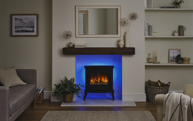 The Hinton Black Stove in a modern living room setting with ambient lighting.